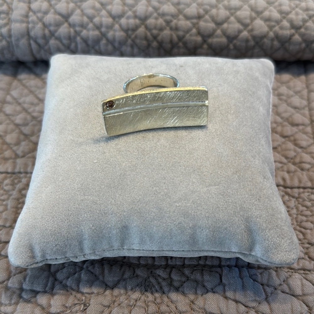 Bague rectangulaire en argent poli avec petit brillant.